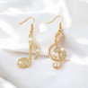 Boucles d'oreilles dorées notes de musique asymétriques