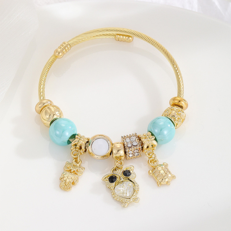 Bracelet charms doré hibou et perles bleues Acier