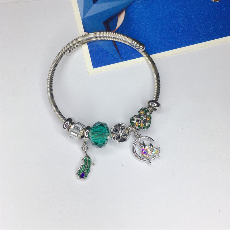 Bracelet charms argenté plume de paon et perle verte Acier