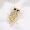 Broche dorée hibou strass blanc