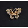 Broche dorée papillon ajouré avec strass