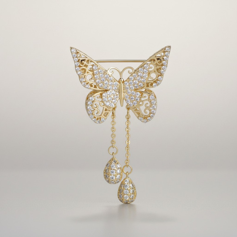 Broche dorée papillon strass et chaînettes